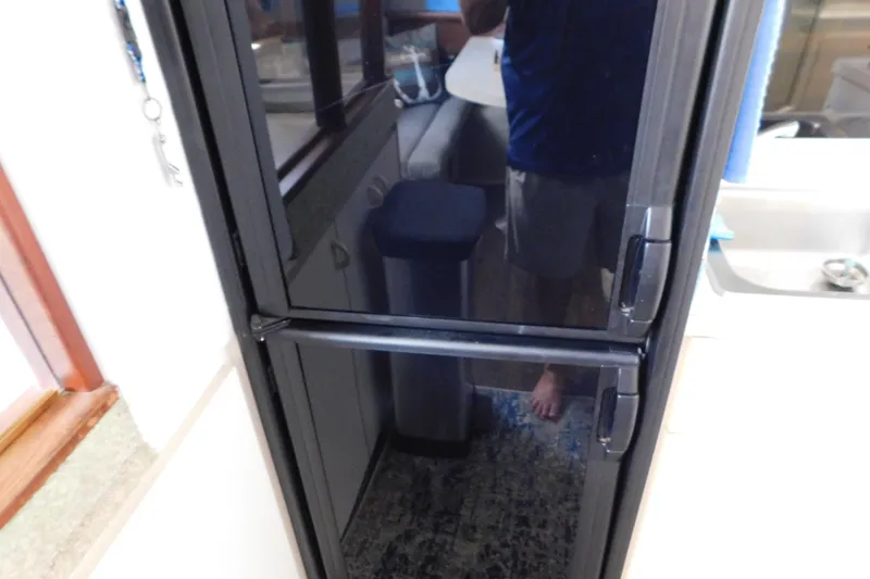 Slide: The Image of Black refrigerator in the kitchen of a 1992 Silverton 41 Aft Cabin boat. - 66