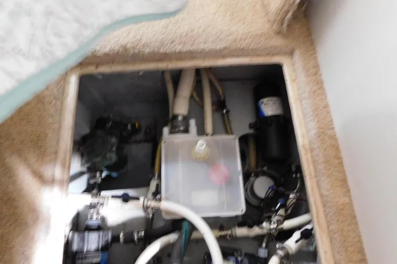 Slide: The Image of 1992 Silverton 41 Aft Cabin engine compartment with visible plumbing and mechanical components. - 104