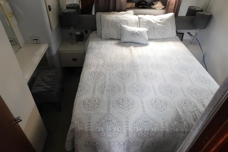 Slide: The Image of Cozy bedroom in 1992 Silverton 41 Aft Cabin yacht with elegant bedding and decor. - 100