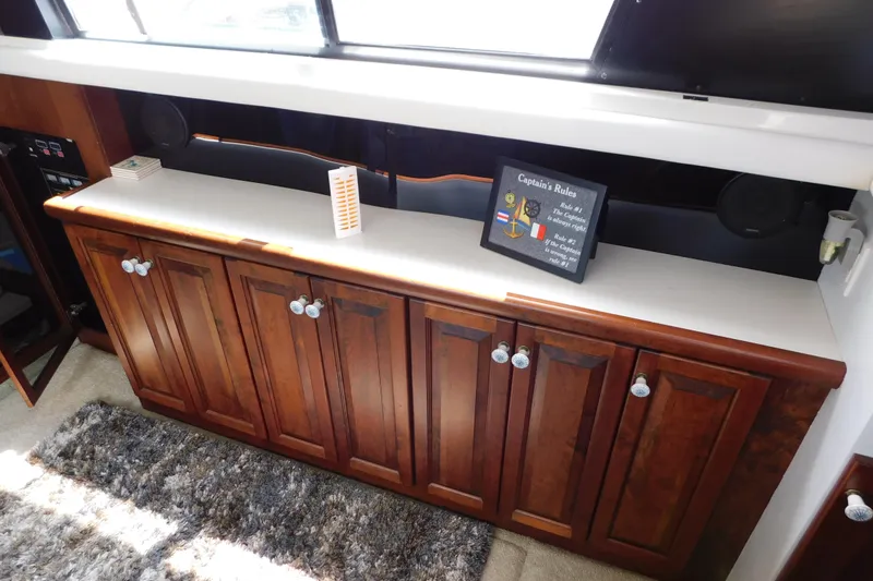Slide: The Image of 1992 Silverton 41 Aft Cabin interior with wooden cabinets and decorative sign. - 45