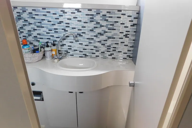 Slide: The Image of Bathroom sink area in 1992 Silverton 41 Aft Cabin with mosaic tile backsplash. - 106