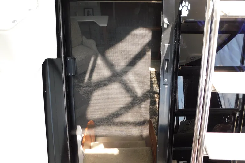 Slide: The Image of Stairway entrance on a 1992 Silverton 41 Aft Cabin yacht, featuring a screen door. - 42