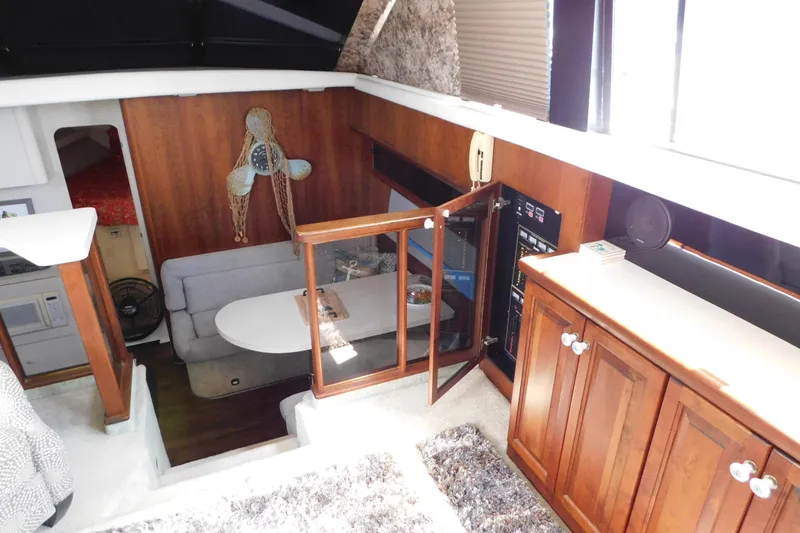 Slide: The Image of 1992 Silverton 41 Aft Cabin interior with wood cabinetry and cozy seating area. - 48