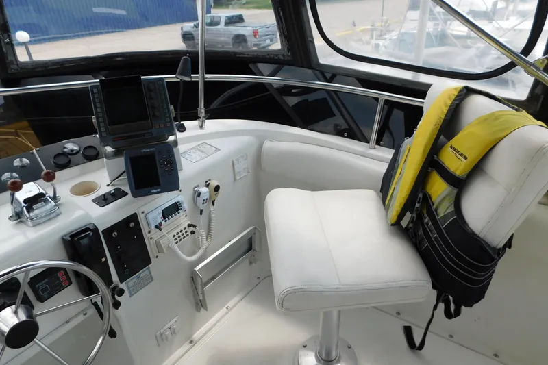Slide: The Image of 1992 Silverton 41 Aft Cabin helm with navigation equipment and life jacket on seat. - 30