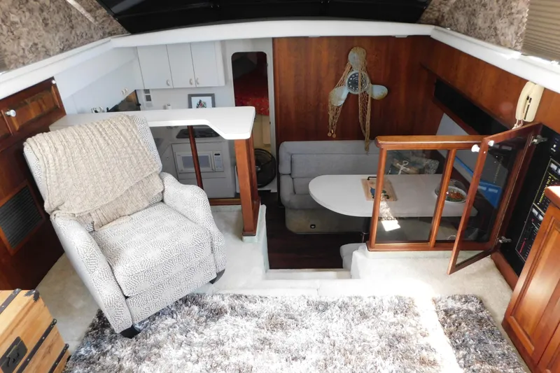 Slide: The Image of Interior of 1992 Silverton 41 Aft Cabin yacht with cozy seating and nautical decor. - 49