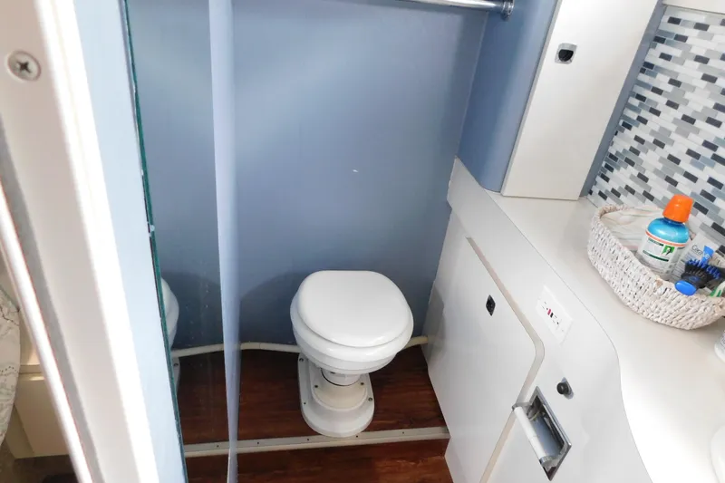 Slide: The Image of 1992 Silverton 41 Aft Cabin bathroom with toilet, sink, and storage. - 108