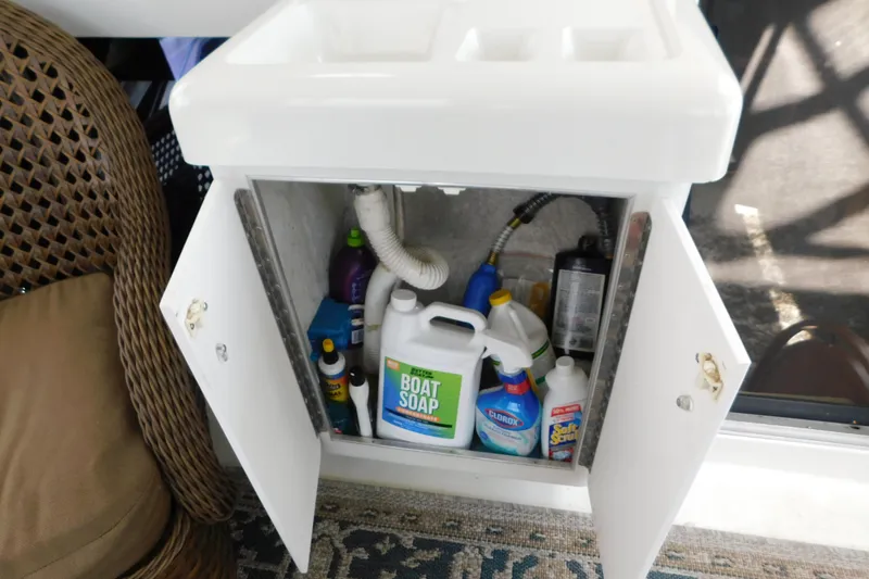 Slide: The Image of Open cabinet on 1992 Silverton 41 Aft Cabin with cleaning supplies and boat soap. - 41