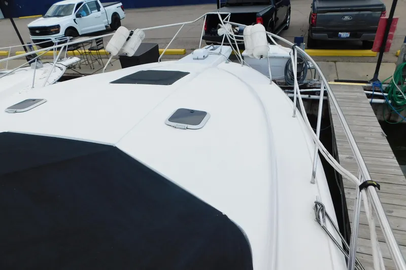 Slide: The Image of 1992 Silverton 41 Aft Cabin yacht docked at marina with visible deck and railings. - 14