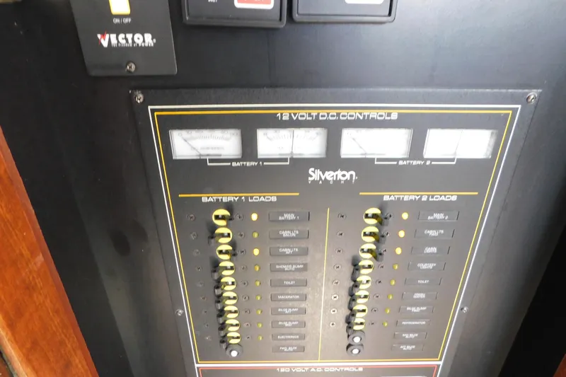 Slide: The Image of Control panel of a 1992 Silverton 41 Aft Cabin boat, featuring battery load switches. - 53