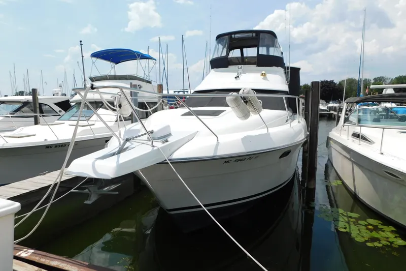 Slide: The Image of 1992 Silverton 41 Aft Cabin yacht docked at marina, surrounded by other boats. - 4
