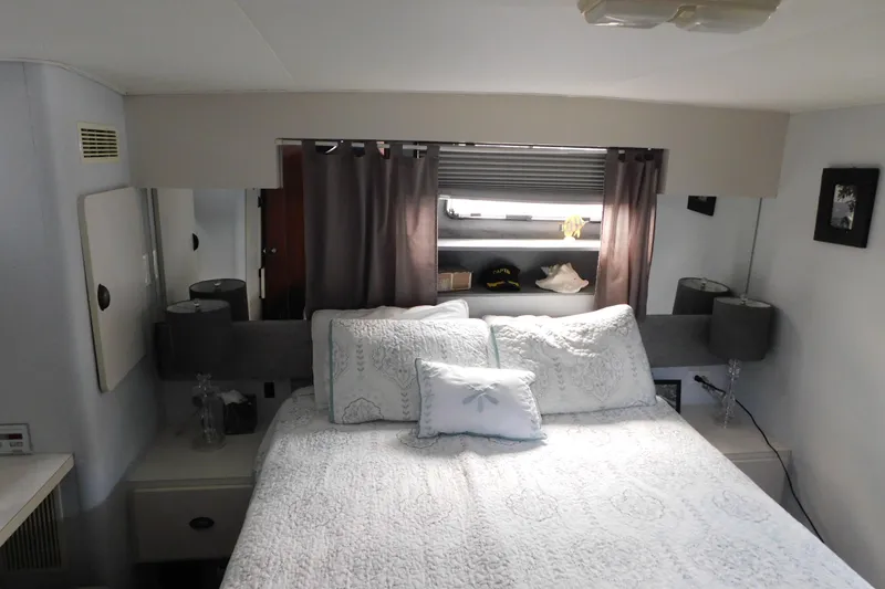 Slide: The Image of Cozy bedroom interior of 1992 Silverton 41 Aft Cabin yacht with elegant bedding and decor. - 102
