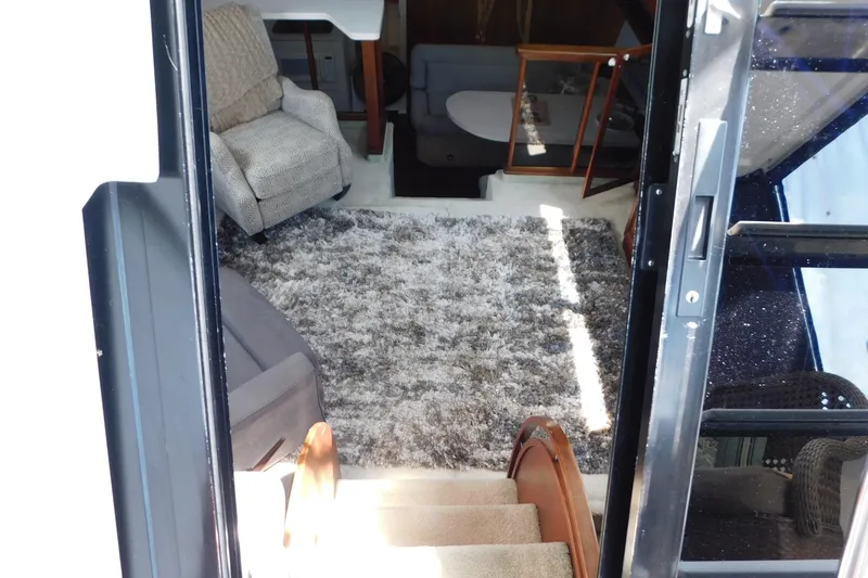 Slide: The Image of Interior view of 1992 Silverton 41 Aft Cabin with cozy seating and plush carpet. - 43