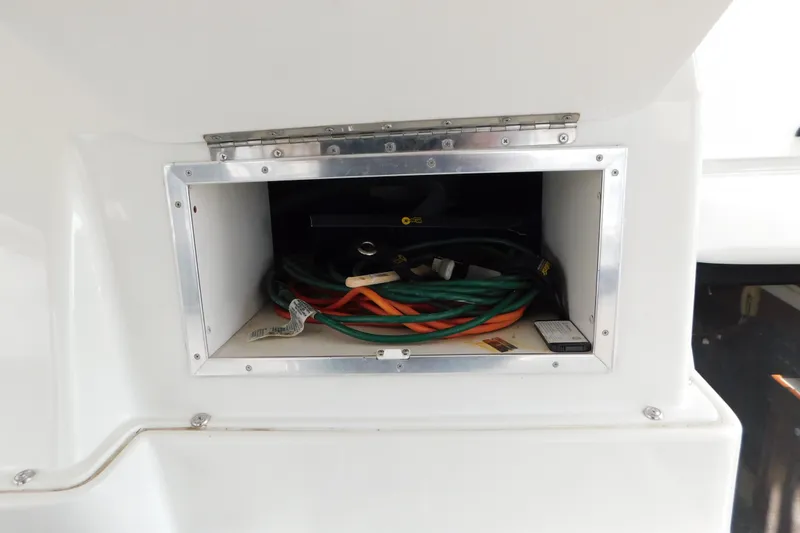 Slide: The Image of Storage compartment on a 1992 Silverton 41 Aft Cabin boat with cables and equipment. - 39