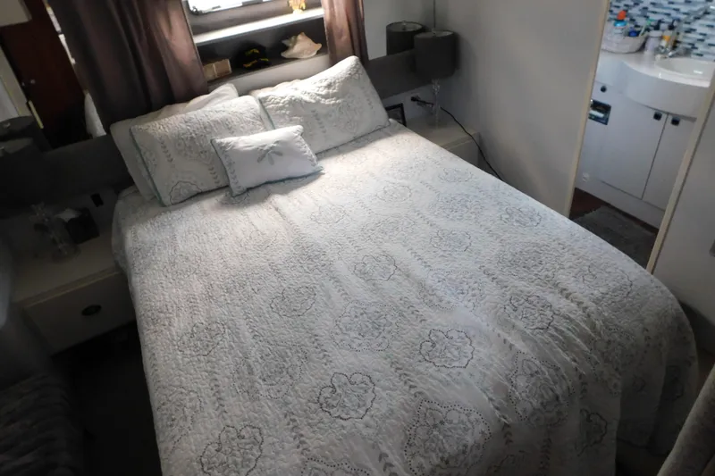 Slide: The Image of Cozy bedroom in 1992 Silverton 41 Aft Cabin yacht with elegant bedding and decor. - 101