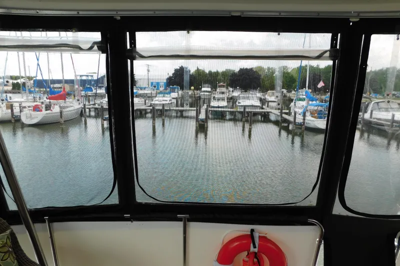 Slide: The Image of View from 1992 Silverton 41 Aft Cabin, overlooking marina with docked boats. - 7