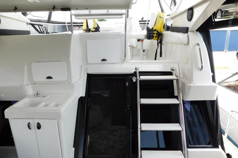 Slide: The Image of 1992 Silverton 41 Aft Cabin interior with stairs, sink, and storage compartments. - 12