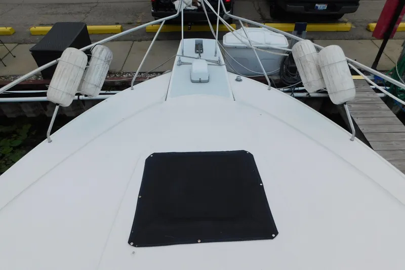 Slide: The Image of 1992 Silverton 41 Aft Cabin boat deck with fenders and dock view. - 15