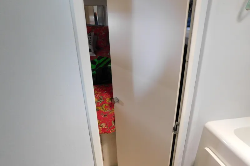 Slide: The Image of Interior view of a 1992 Silverton 41 Aft Cabin, featuring a partially open door. - 74
