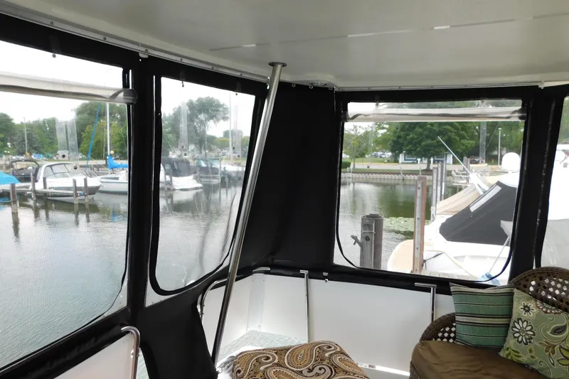 Slide: The Image of 1992 Silverton 41 Aft Cabin interior with marina view through windows. - 8