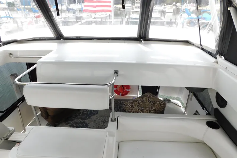 Slide: The Image of 1992 Silverton 41 Aft Cabin interior with seating and marina view. - 32