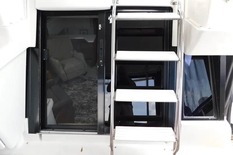 Slide: The Image of 1992 Silverton 41 Aft Cabin yacht interior with ladder and seating area. - 20