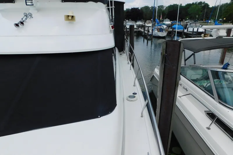 Slide: The Image of 1992 Silverton 41 Aft Cabin yacht docked at marina with other boats. - 19