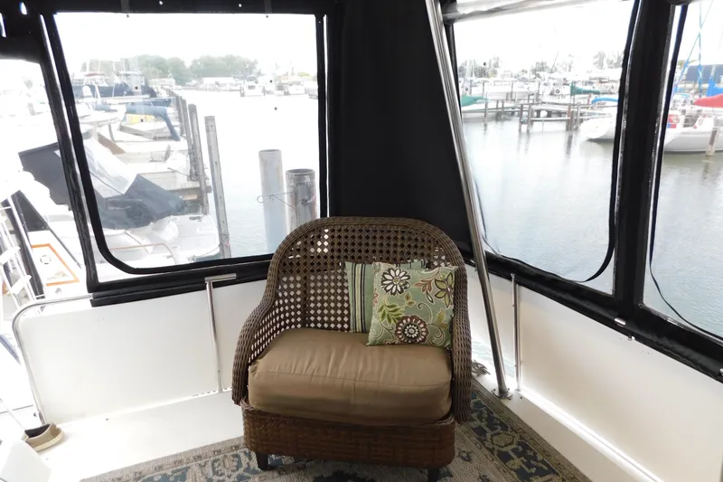 Slide: The Image of Cozy seating area on 1992 Silverton 41 Aft Cabin yacht with marina view. - 6