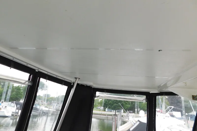 Slide: The Image of Interior view of 1992 Silverton 41 Aft Cabin boat with marina background. - 9