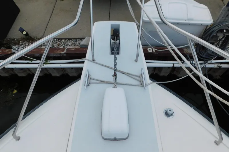 Slide: The Image of Bow of 1992 Silverton 41 Aft Cabin with anchor and railing at dock. - 16