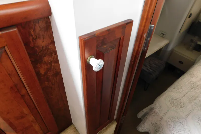 Slide: The Image of Wooden interior of 1992 Silverton 41 Aft Cabin with decorative door knob. - 98