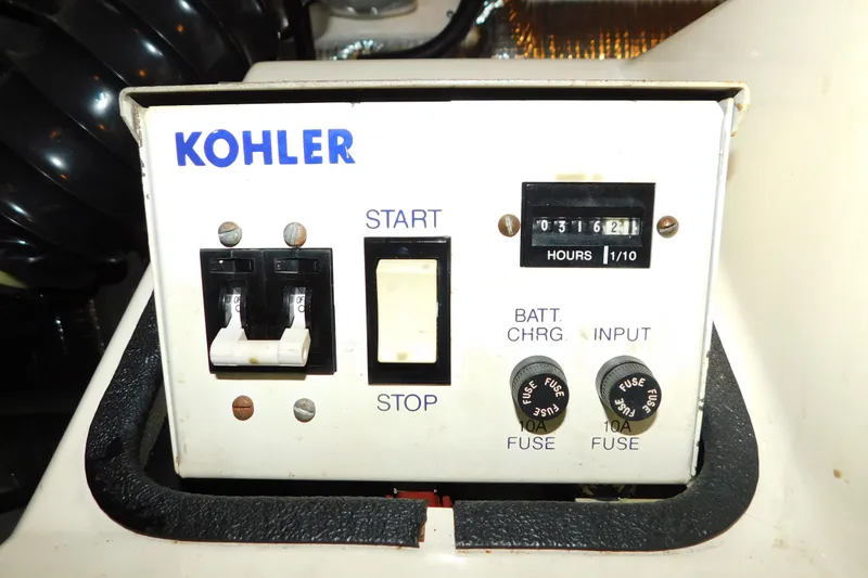 Slide: The Image of Kohler generator control panel on 1992 Silverton 41 Aft Cabin boat, showing hours and fuses. - 95