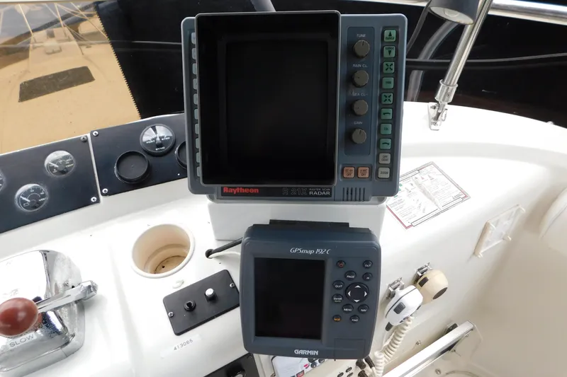 Slide: The Image of Control panel of a 1992 Silverton 41 Aft Cabin with Raytheon radar and Garmin GPS. - 24