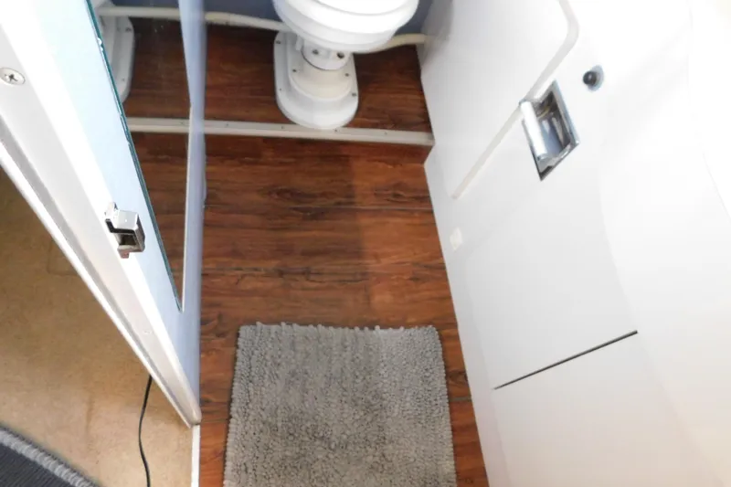 Slide: The Image of 1992 Silverton 41 Aft Cabin bathroom with wood flooring and a toilet. - 109