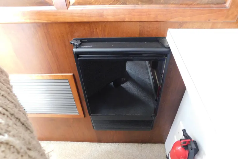 Slide: The Image of Interior of 1992 Silverton 41 Aft Cabin with mini fridge and fire extinguisher. - 85