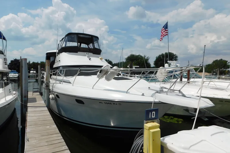 Slide: The Image of 1992 Silverton 41 Aft Cabin yacht docked at marina with American flag. - 5