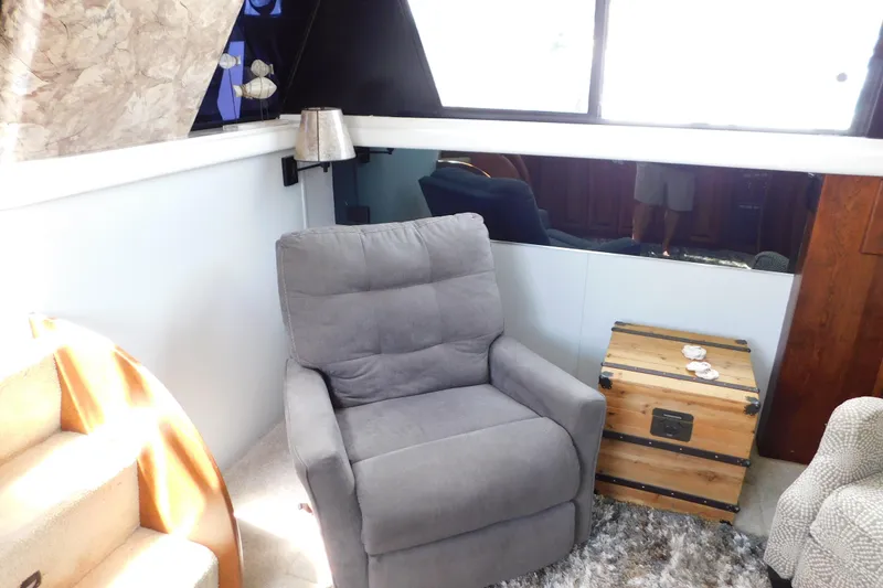 Slide: The Image of Cozy interior of 1992 Silverton 41 Aft Cabin with gray recliner and wooden chest. - 50