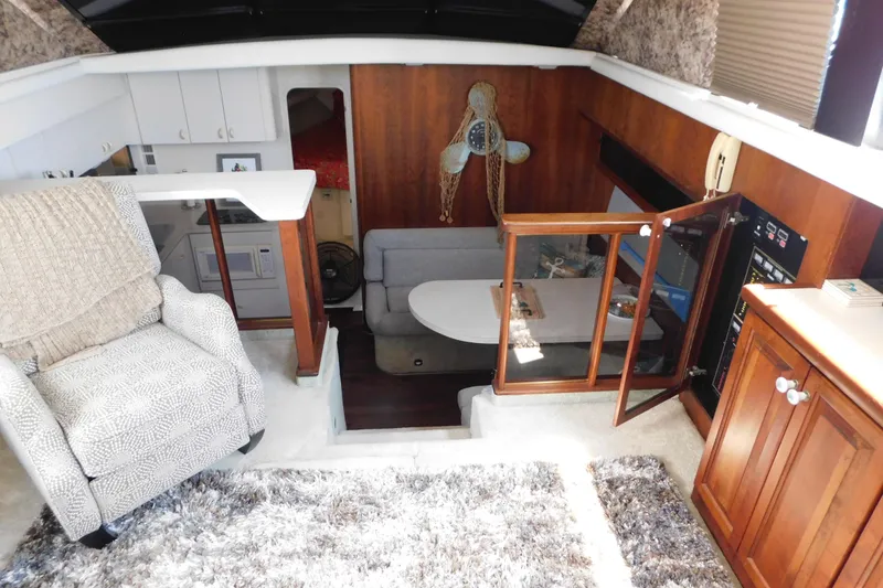 Slide: The Image of Interior of 1992 Silverton 41 Aft Cabin yacht with cozy seating and wooden cabinetry. - 47