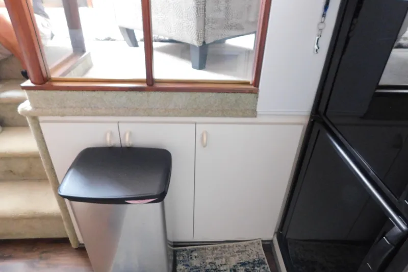Slide: The Image of Interior of 1992 Silverton 41 Aft Cabin with trash bin and cabinetry. - 69