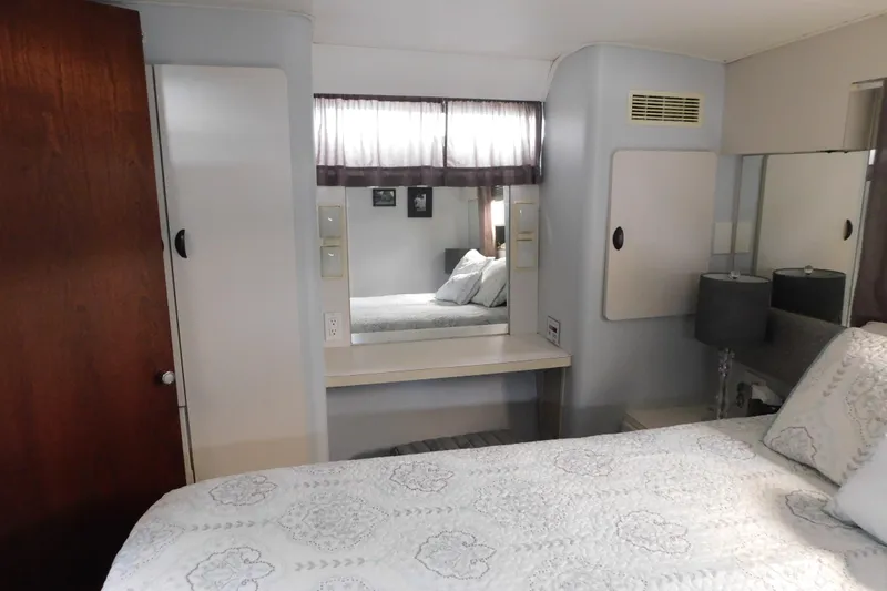 Slide: The Image of Interior of 1992 Silverton 41 Aft Cabin with bed, mirror, and storage cabinets. - 111
