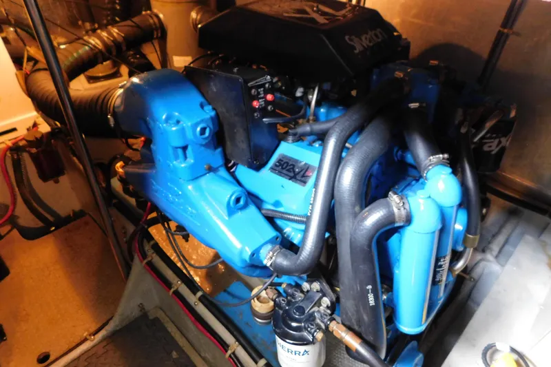 Slide: The Image of Engine room of a 1992 Silverton 41 Aft Cabin boat, featuring a blue engine. - 90