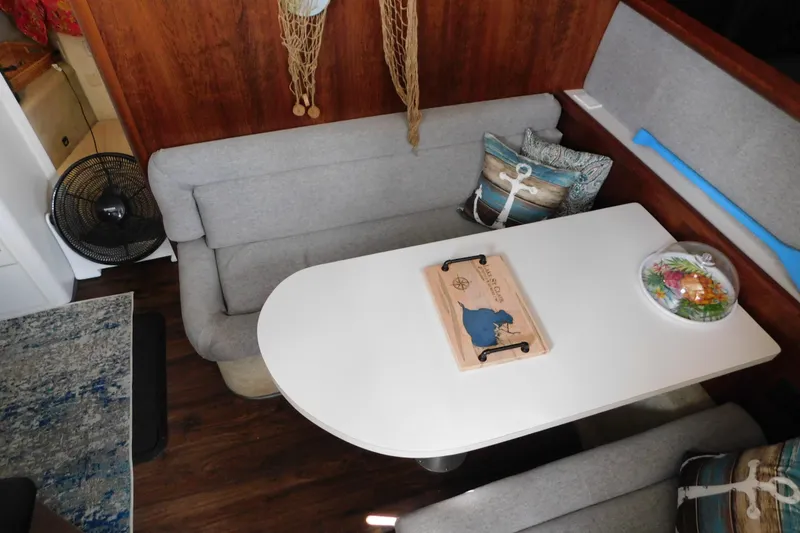 Slide: The Image of Cozy dining area in 1992 Silverton 41 Aft Cabin with nautical-themed decor. - 57