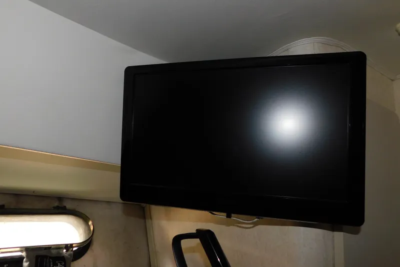 Slide: The Image of Flat-screen TV mounted in a 1992 Silverton 41 Aft Cabin interior. - 79