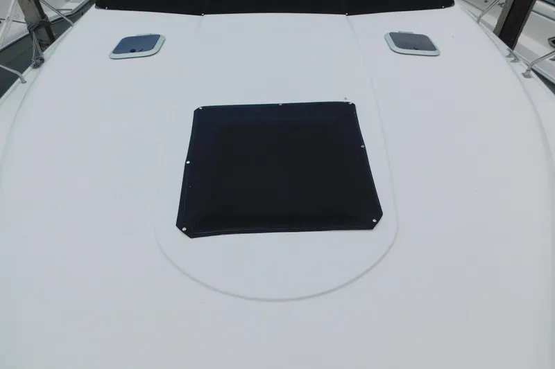 Slide: The Image of 1992 Silverton 41 Aft Cabin boat deck with covered hatch and windows. - 18