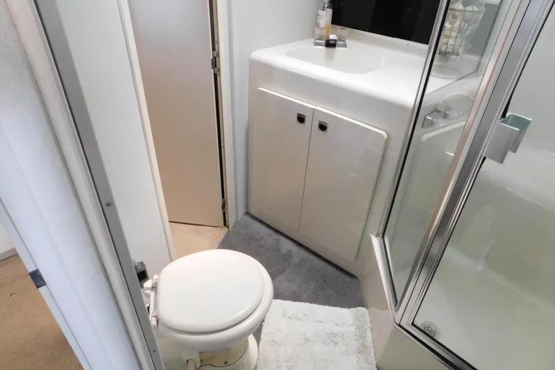 Slide: The Image of Bathroom interior of 1992 Silverton 41 Aft Cabin yacht, featuring toilet, sink, and shower. - 72