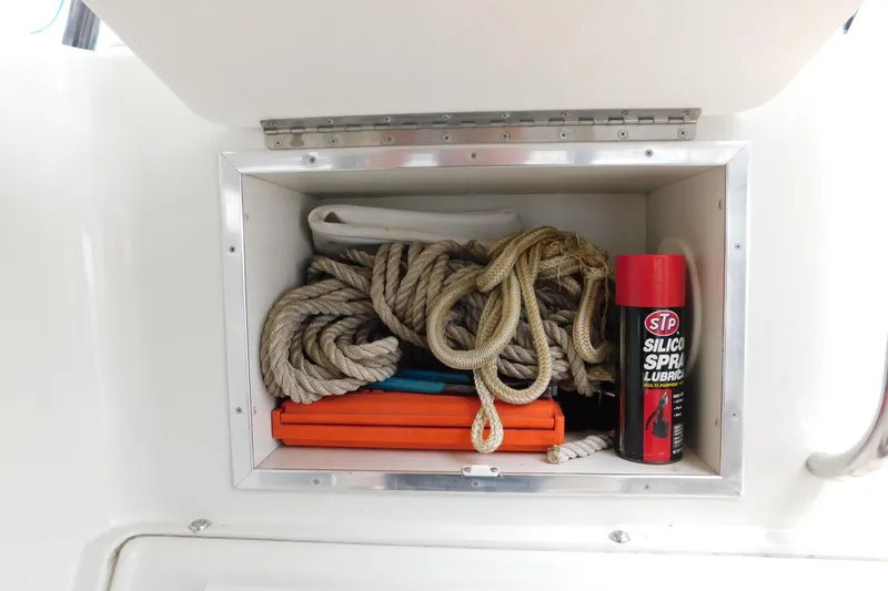 Slide: The Image of Storage compartment on a 1992 Silverton 41 Aft Cabin with ropes and silicone spray. - 37