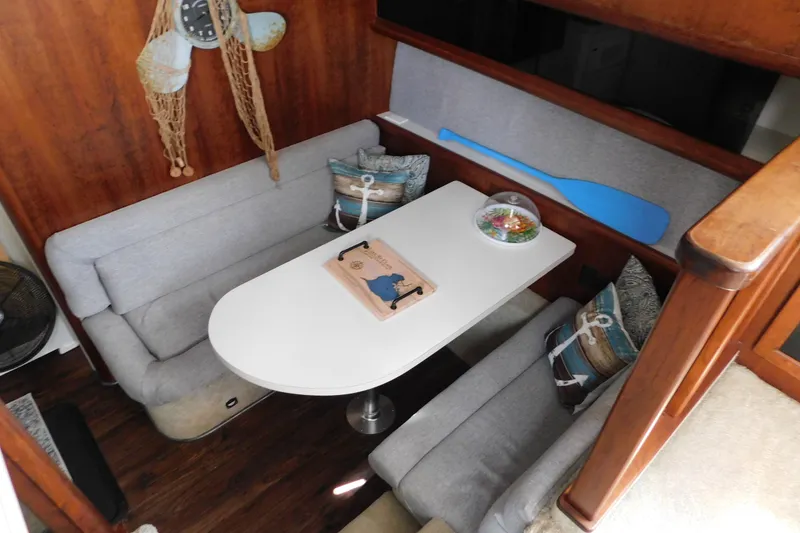 Slide: The Image of Cozy dining area in 1992 Silverton 41 Aft Cabin with nautical decor and wooden accents. - 55