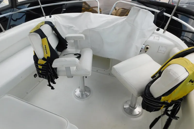 Slide: The Image of 1992 Silverton 41 Aft Cabin boat interior with white seating and life jackets. - 21
