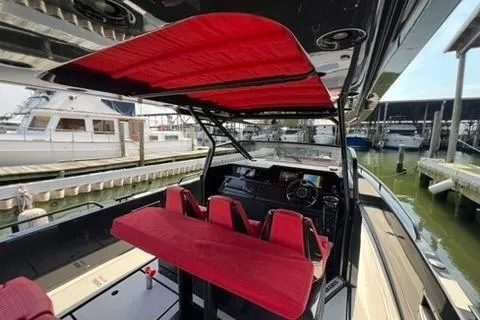 Slide: The Image of 2021 BRABUS 900 Shadow yacht interior with red seating and canopy at a marina. - 32