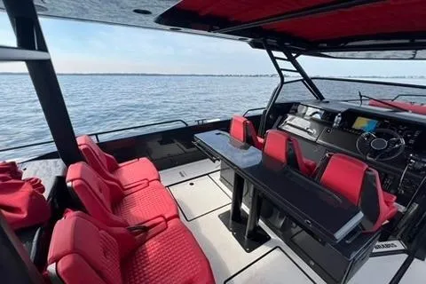 Slide: The Image of Interior of 2021 BRABUS 900 Shadow boat with red seating and sleek design. - 22