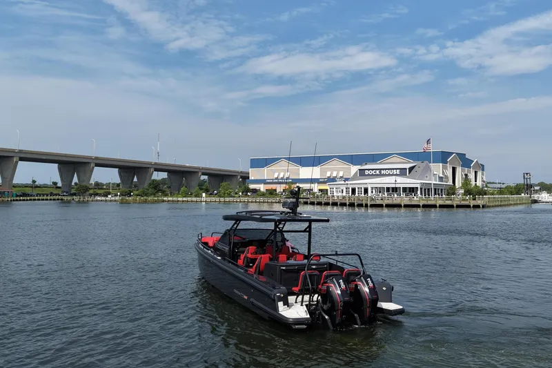 Slide: The Image of BRABUS 900 Shadow 2021 boat cruising near a dock house under a blue sky. - 5